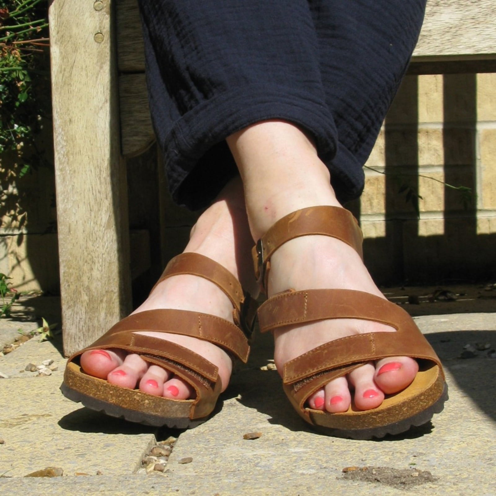 tan oak & hyde daisy sandals worn outdoors showing open toe design and cork footbed