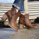 model standing on concrete wearing Eastside 2 western boots with light blue jeans