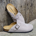 pair image of gibraltar 2 clogs in beige resting on a stone outdoors