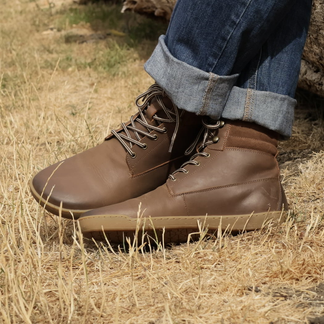 model wearing hawthorn mens barefoot boots in dark brown with blue jeans