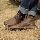 model wearing hawthorn mens barefoot boots in dark brown with blue jeans