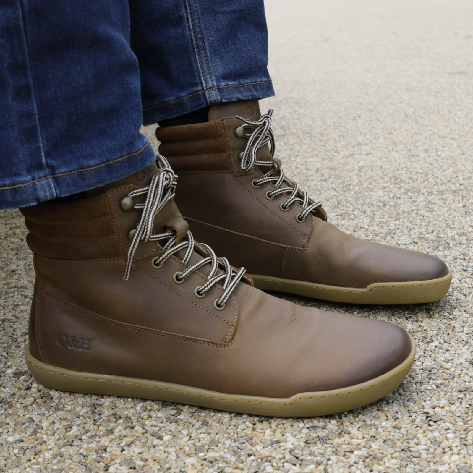 model sitting on bench wearing hawthorn mens barefoot boots in brown
