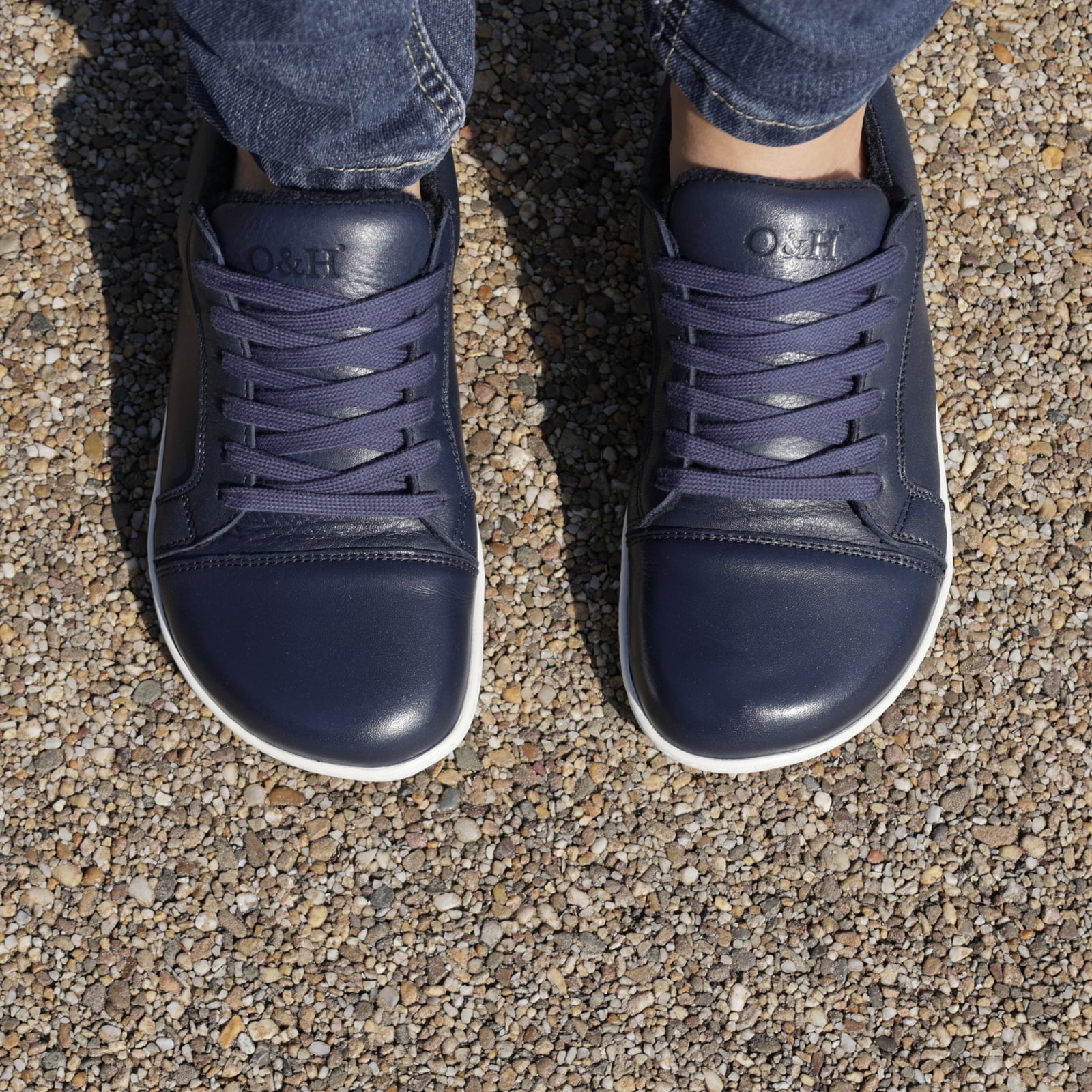 top down view of hazel barefoot trainers in navy on model showing toe shape