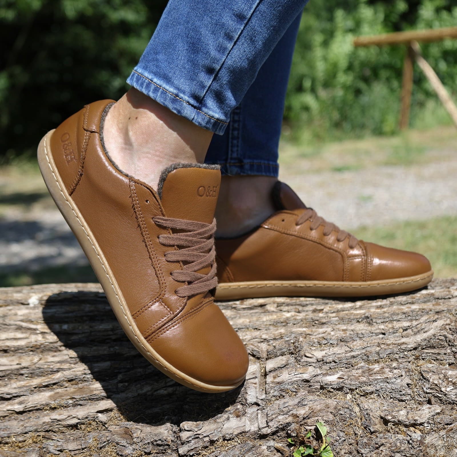 model wearing brown barefoot trainers with blue jeans