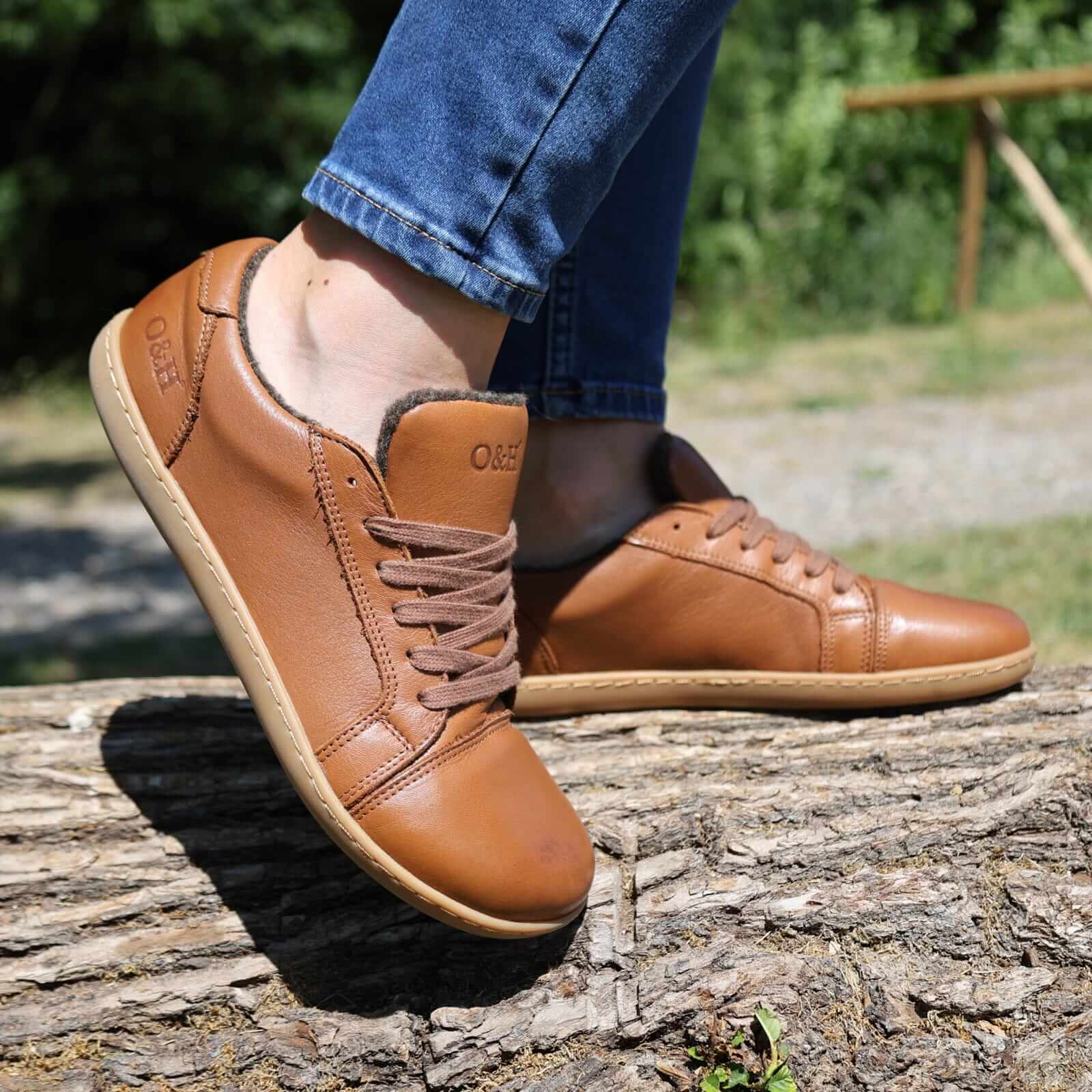 model wearing brown barefoot trainers with blue jeans