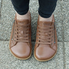 model wearing hazel zip barefoot trainers in tan showing view of toe box