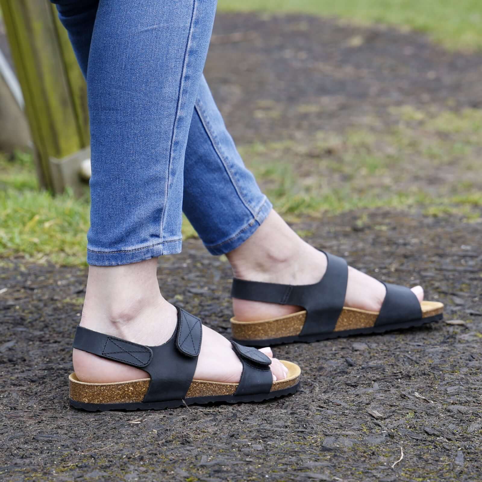 black oak & hyde iris adjustable sandals worn outdoors showing rear strap fit and cork footbed