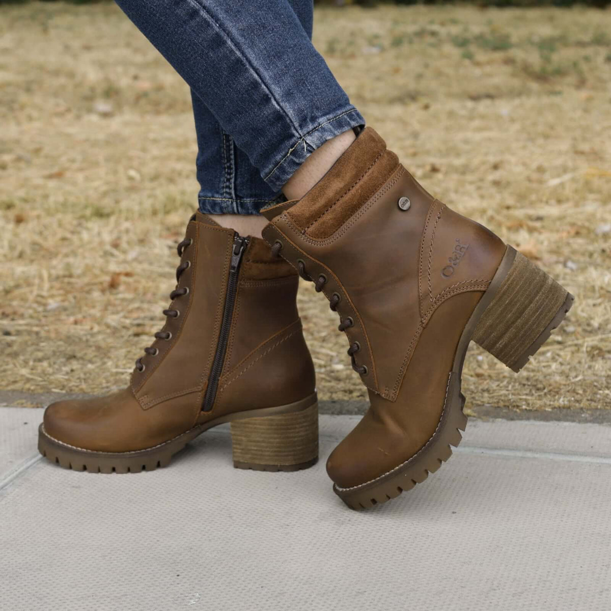 model wearing kensington 2 dark brown ankle boots with blue jeans on a pavement