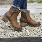 dark brown oak & hyde kensington zip ankle boots worn with jeans outdoors on gravel path