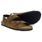 Pair of tan leather fisherman sandals, one showing the patterned black rubber sole and cork footbed