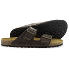 Dark brown leather fisherman sandals with two buckle straps, cork footbeds, and textured rubber outsole visible