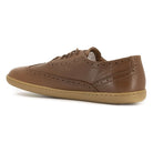 inside angled view of maple brogue barefoot shoes in tan showing brogue pattern detail