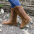 model wearing mesquite barefoot cowboy boots in cognac on outdoor path