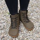 model standing on gravel path wearing mulberry barefoot boots in khaki