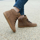 model wearing mulberry light brown barefoot ankle boots with blue jeans outside