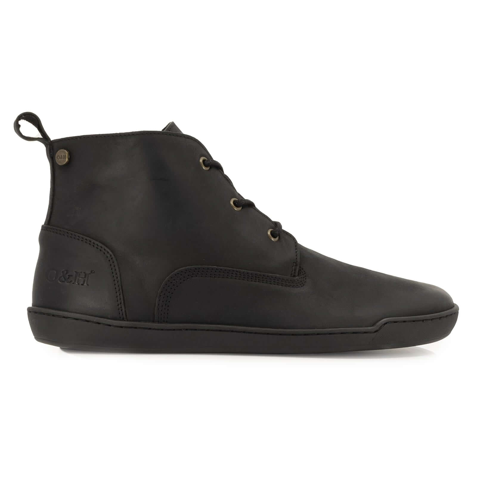 side profile view of spruce barefoot chukka boots in black showing leather upper