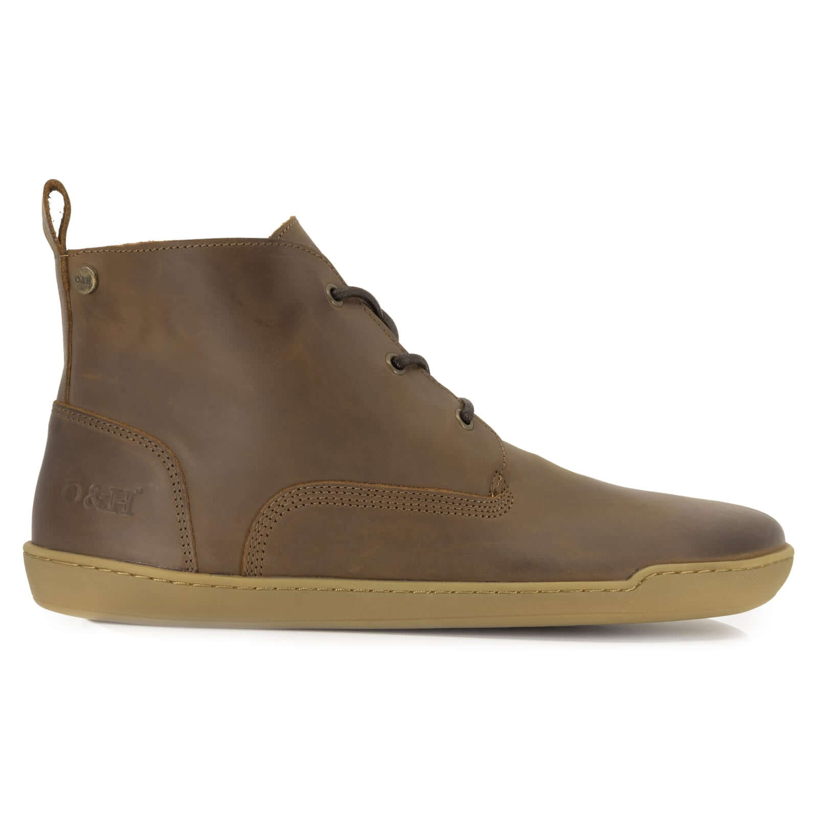 side profile of spruce barefoot boots in brown showing heel logo on white background