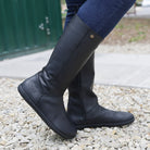 model standing outdoors waring sycamore barefoot boots in black with blue jeans