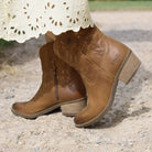 second lifestyle image of model wearing the Texan Ankle boot in tan