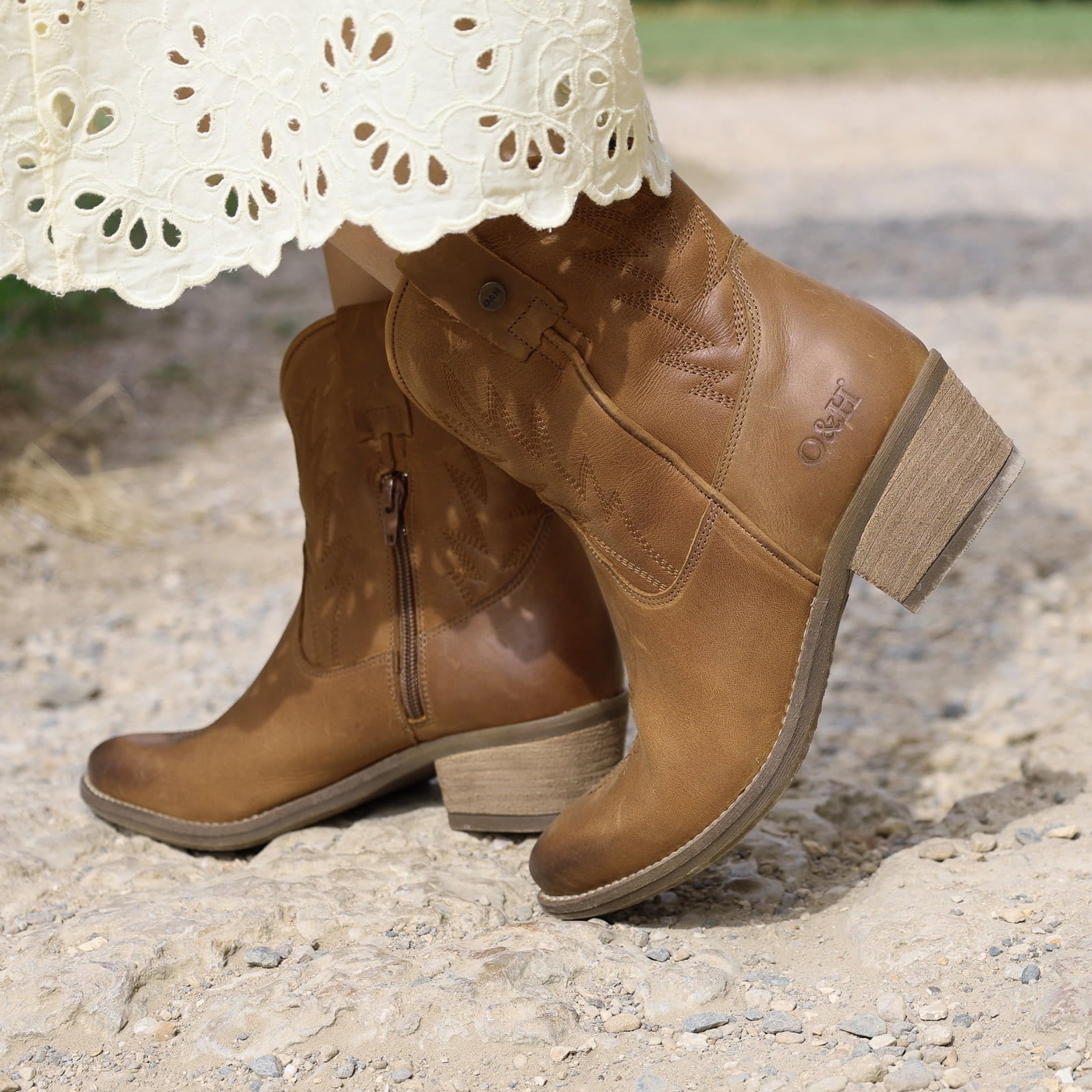 second lifestyle image of model wearing the Texan Ankle boot in tan