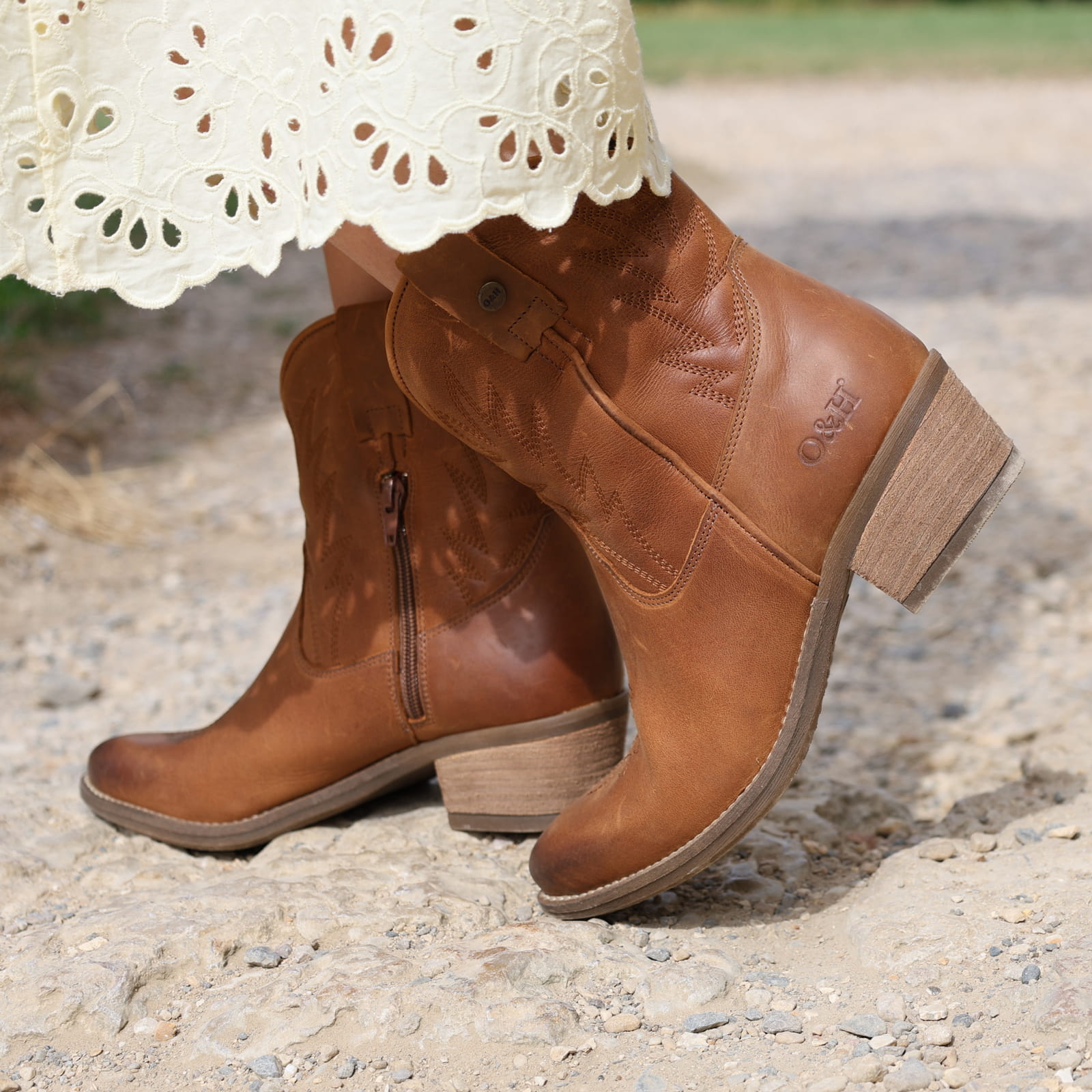 second lifestyle image of model wearing the Texan Ankle boot in tan