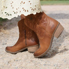 second lifestyle image of model wearing the Texan Ankle boot in tan