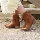 second lifestyle image of model wearing the Texan Ankle boot in tan