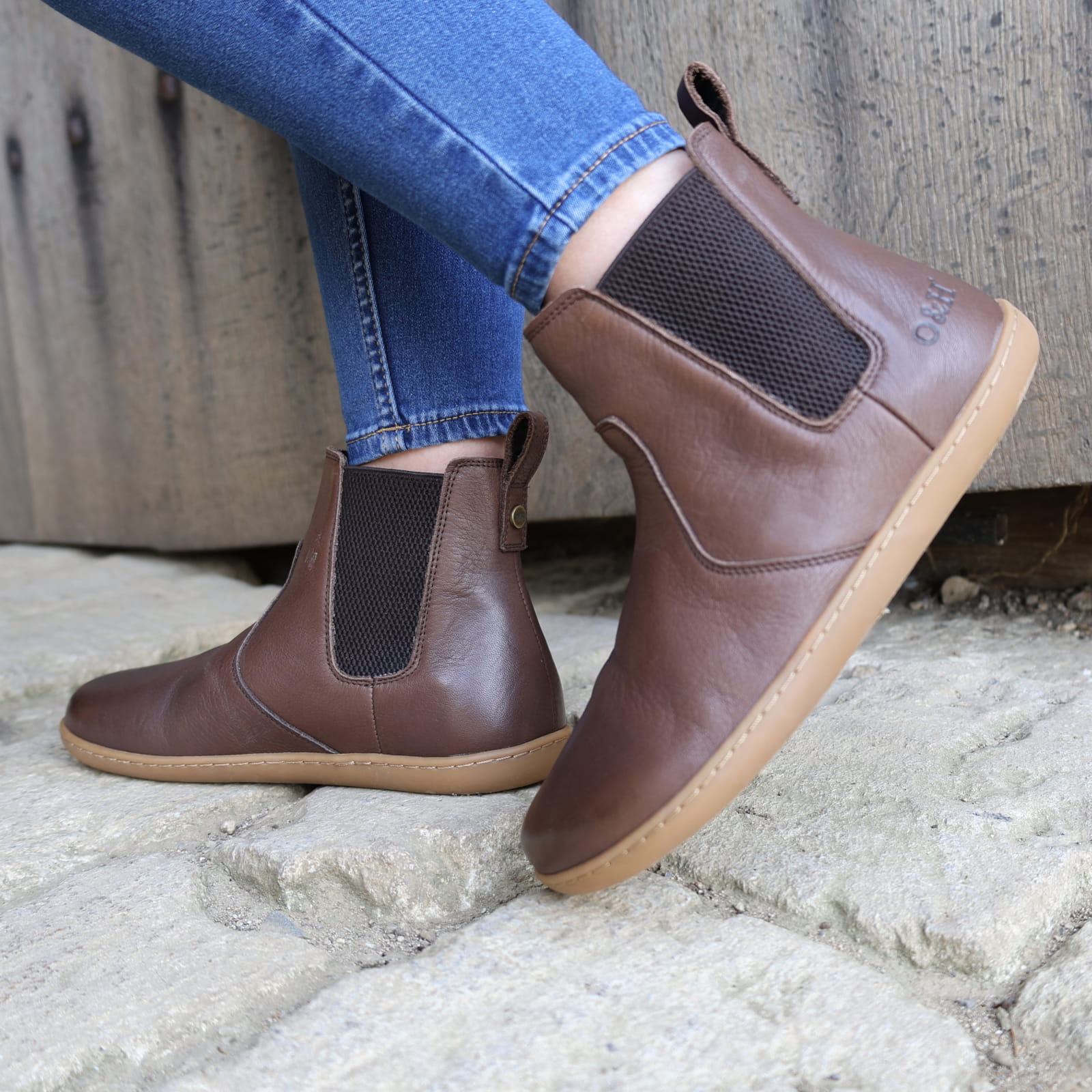 dark brown barefoot boot being worn by a model outside