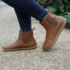 model wearing tan leather barefoot boots outdoors