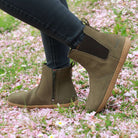 model wearing willow zip barefoot chelsea boots in khaki with black jeans