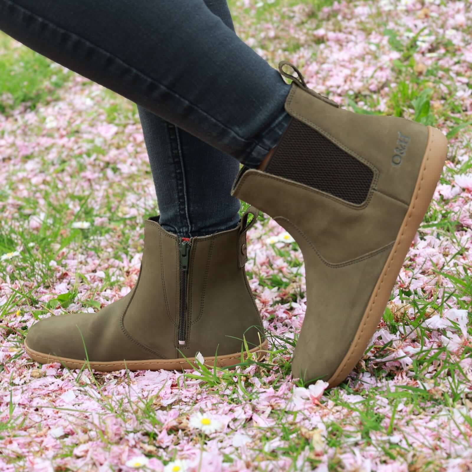model wearing willow zip barefoot chelsea boots in khaki with black jeans