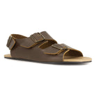 angled front view of brown oak & hyde wisteria barefoot sandals showing wide toe shape and adjustable strap fastening