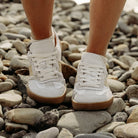 front view of juniper barefoot trainers in white beige being worn by model