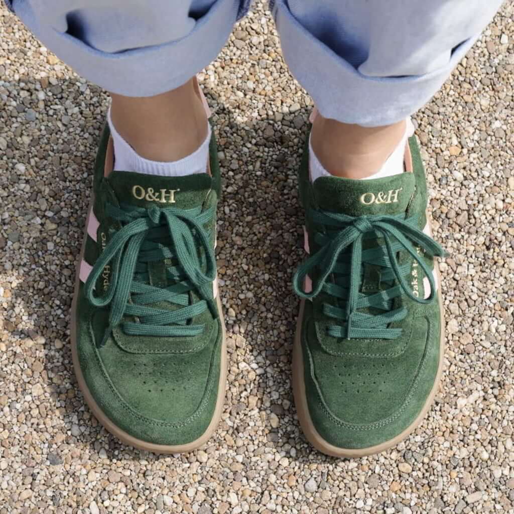 top dow view of model wearing larch trainers in green pink showing toe shape