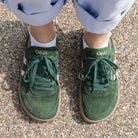 top dow view of model wearing larch trainers in green pink showing toe shape