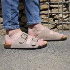 beige oak & hyde malaga adjustable sandals worn outdoors with rolled jeans on pavement