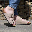 beige oak & hyde malaga adjustable sandals worn outdoors showing adjustable buckles and cork footbed