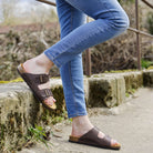dark brown oak & hyde malaga adjustable sandals worn outdoors showing open toe straps and cork footbed
