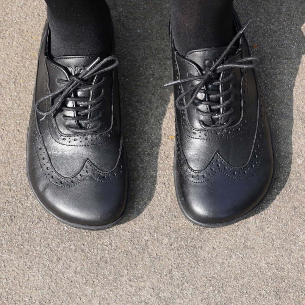 tope down view of womens maple barefoot brogue shoes in black showing toe box shape